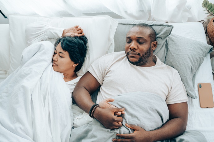 Young couple sleeping in bed