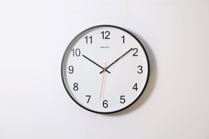 White clock fixed on a white wall