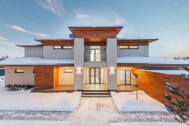 Big house with snow on the ground and roof